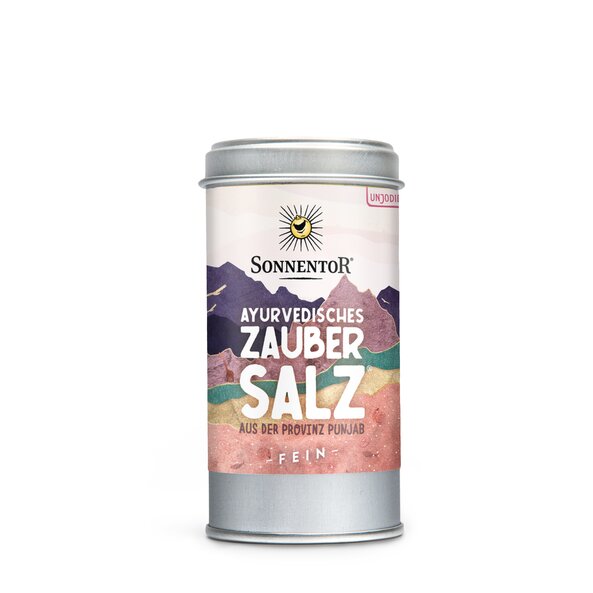 Photo of a spice tin of Ayurveda Magic Salt. On the tin you can see mountains with different colors.